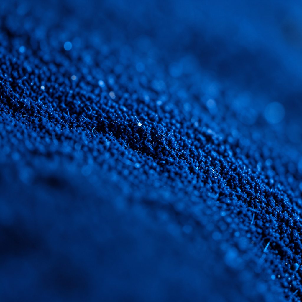 Close-up of glossy dark glass surface with faint fingerprints, sleek device-adjacent mood