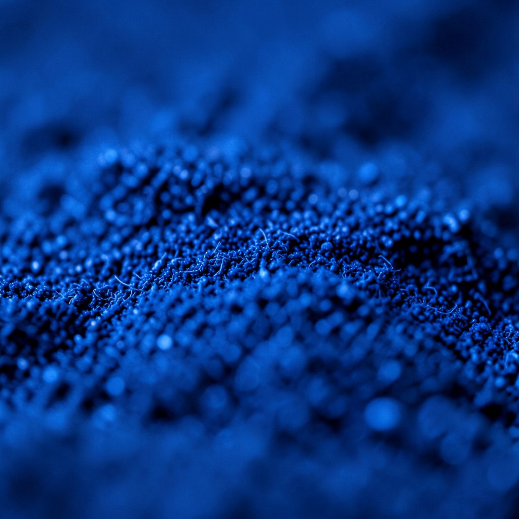 Macro photograph of a deep blue circuit board texture with repeating gold contact points, technical and moody atmosphere.
