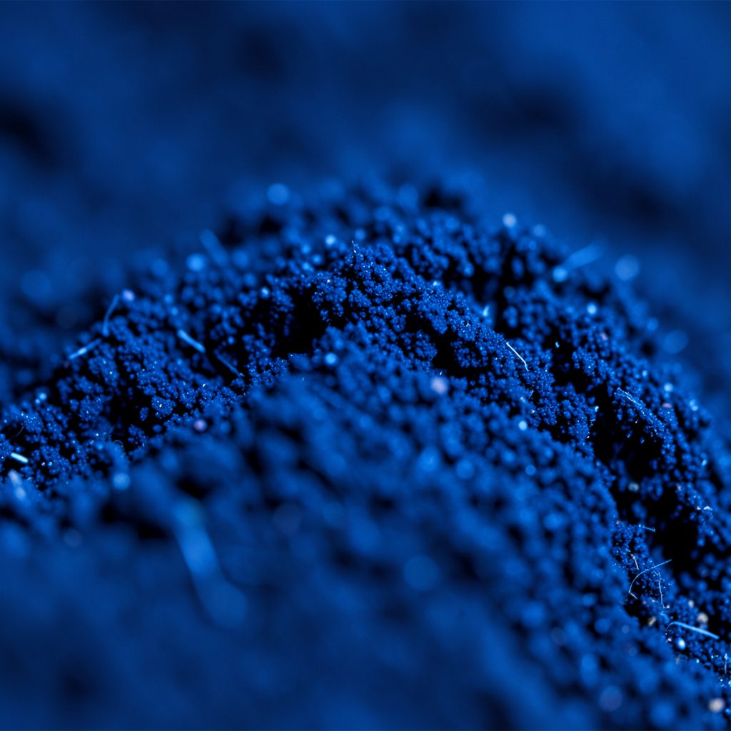 Close-up of a smooth pale glass surface with soft blue reflections, cool tones